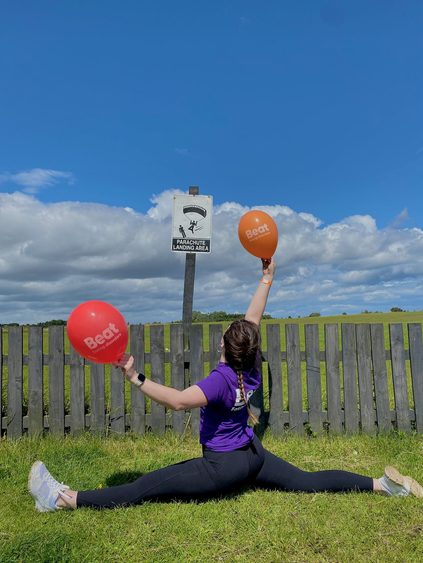 Sara posing in parachute landing area