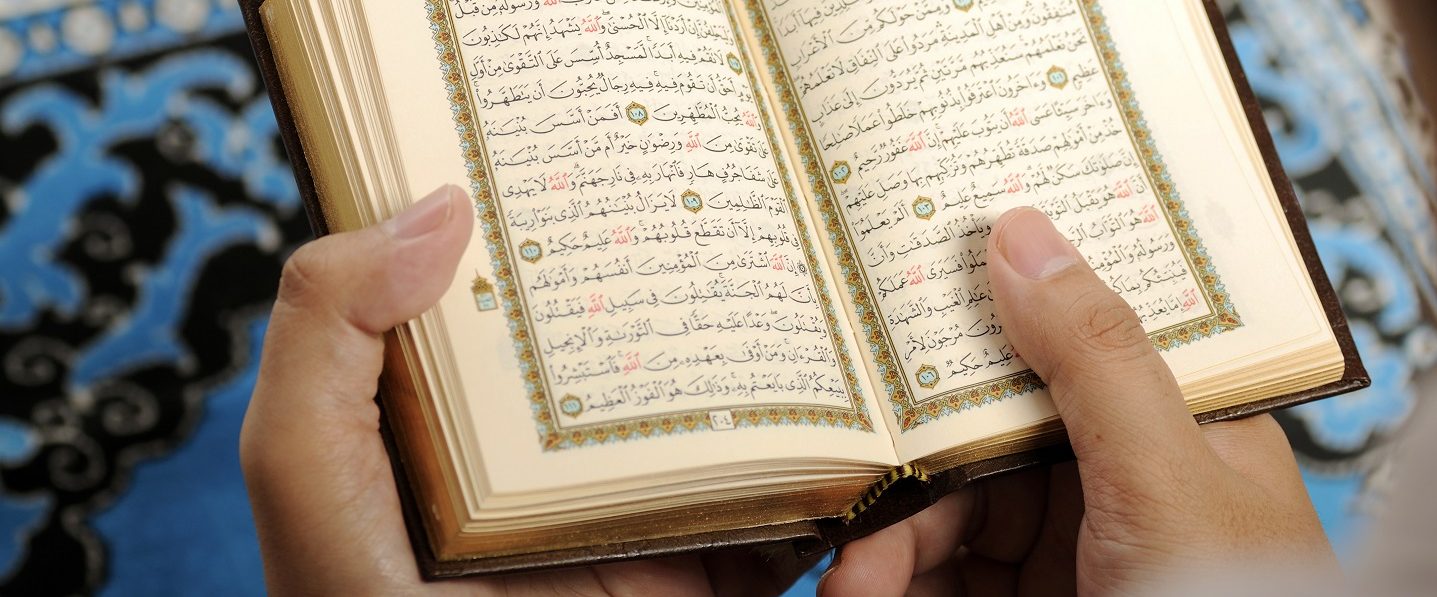 Close up of hands holding Quran