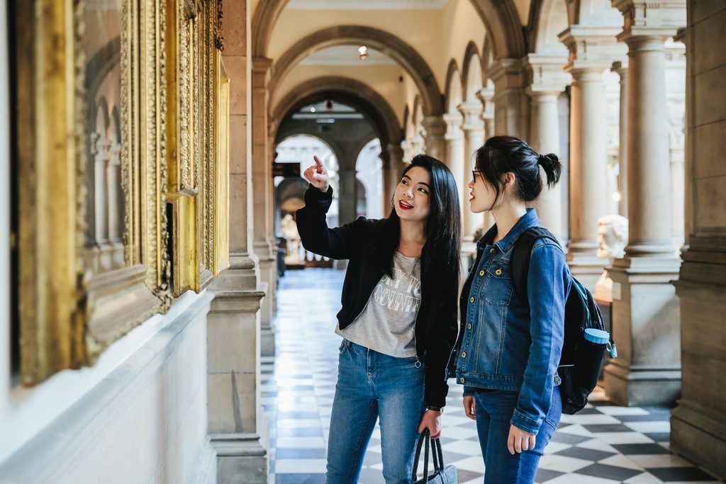 University of Glasgow students talking about an art piece in a museum