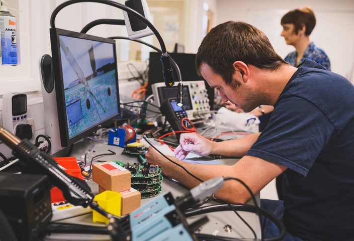 Student working on electronic part