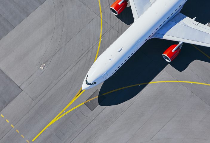 Aerial view of airplane on airport runway