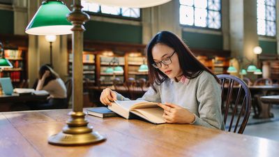 Student reading at the library in Boston