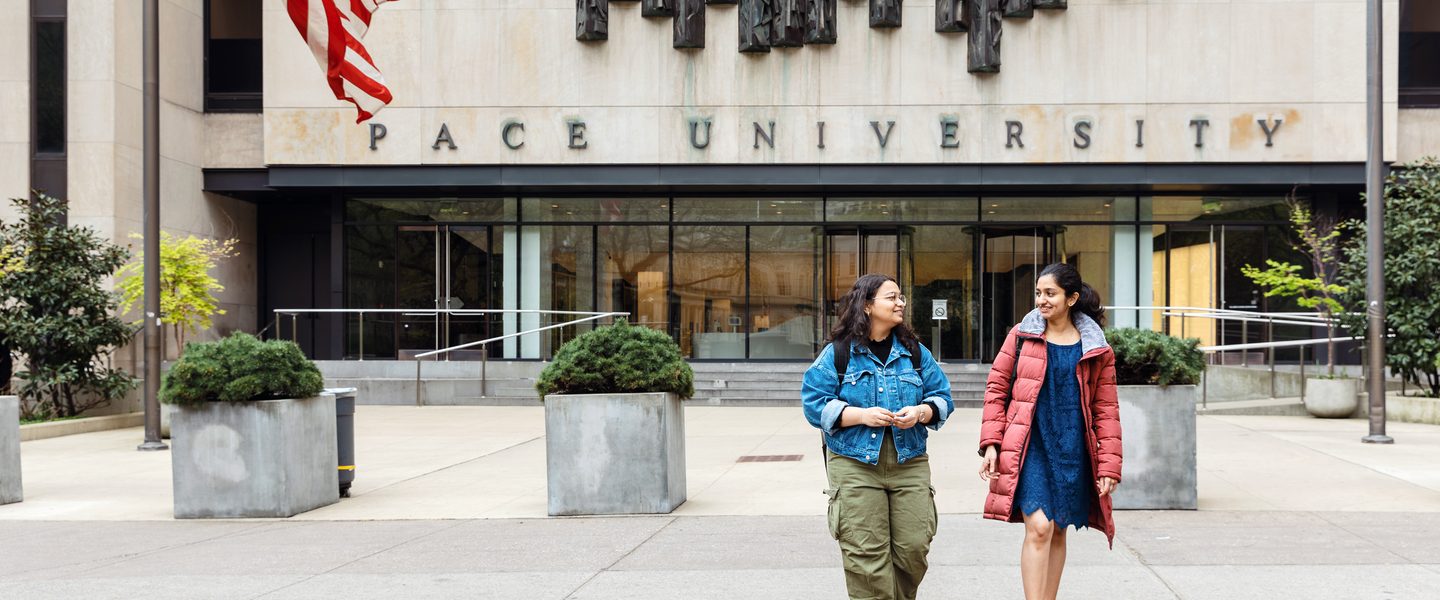 Pace University students walking in campus entrance way