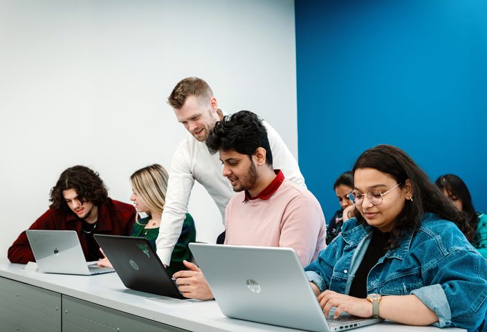 Pace University student engaging with a lecturer in the classroom