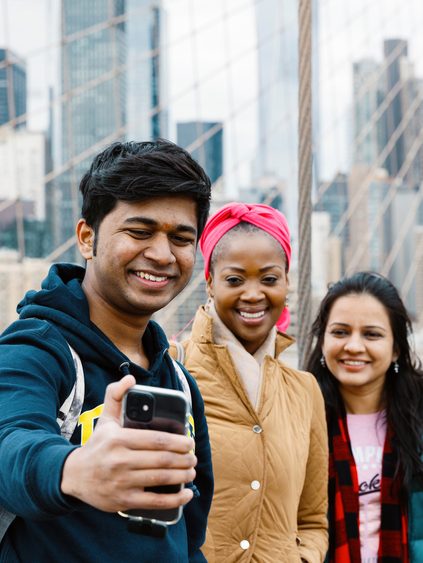 Pace University students taking a group selfie in New York