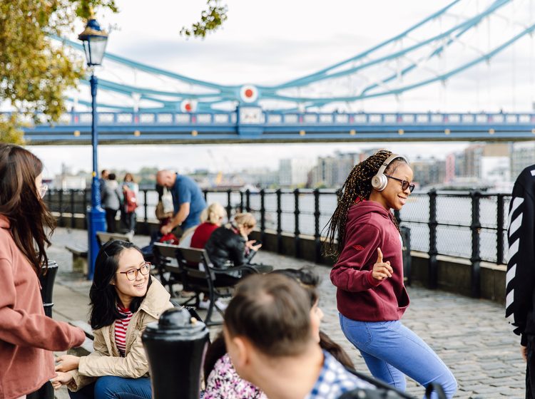 Students socialising by the London Thames