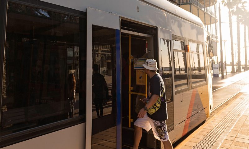 Student taking advantage of public transportation via tram