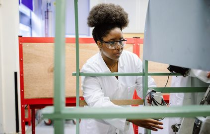 A TUNIC student working in a laboratory