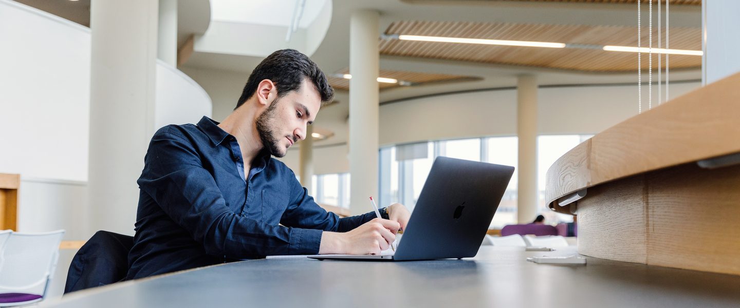 University of Nottingham student studying at the campus library