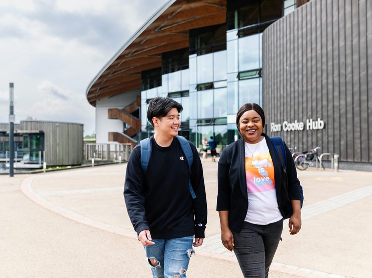 University of York students walking away from the Ron Cooke Hub building