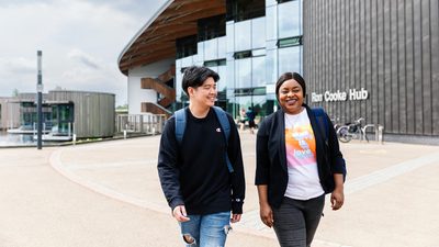 University of York students walking away from the Ron Cooke Hub building