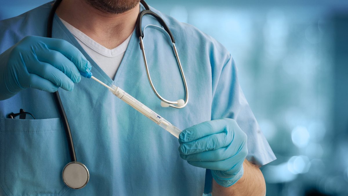 Close up of a healthcare professional holding a tube