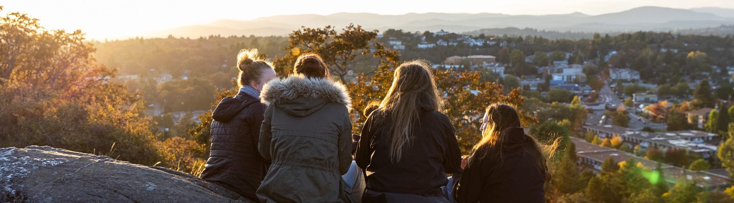 University of Victoria students sitting on the hill to see the view of the city