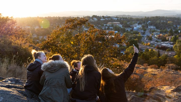 University of Victoria students sitting in the hillside area