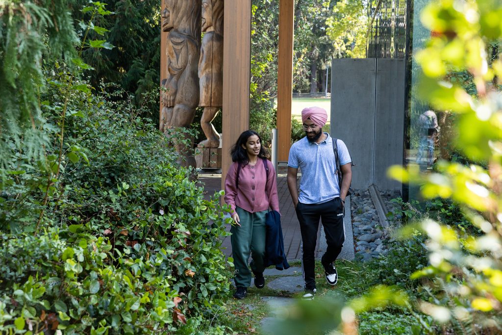 Two University of Victoria students walking on campus