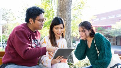 UVic students looking at a tablet