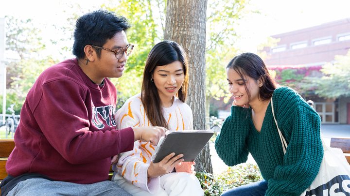 UVic students looking at a tablet