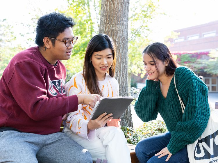 UVic students looking at a tablet