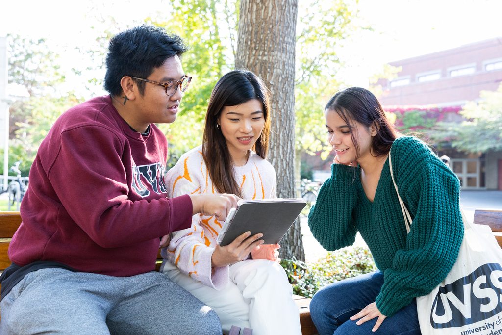 UVic students looking at a tablet