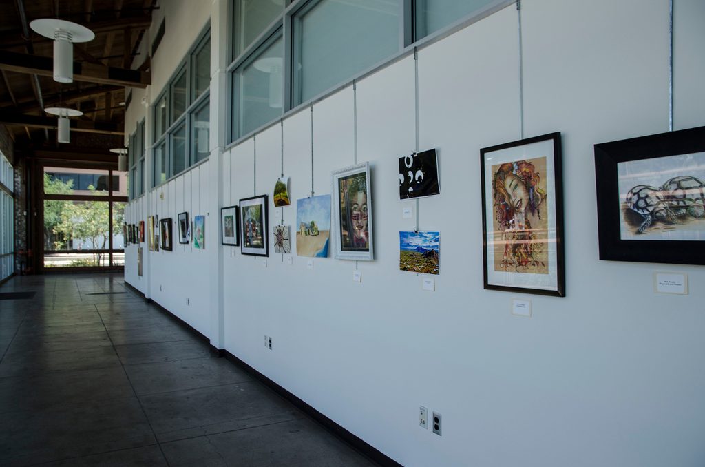 Artwork by students displayed on the wall at ASU downtown campus