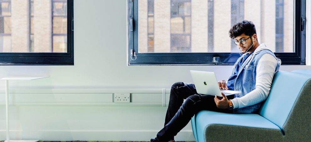 International student at Kaplan International College studying on his laptop