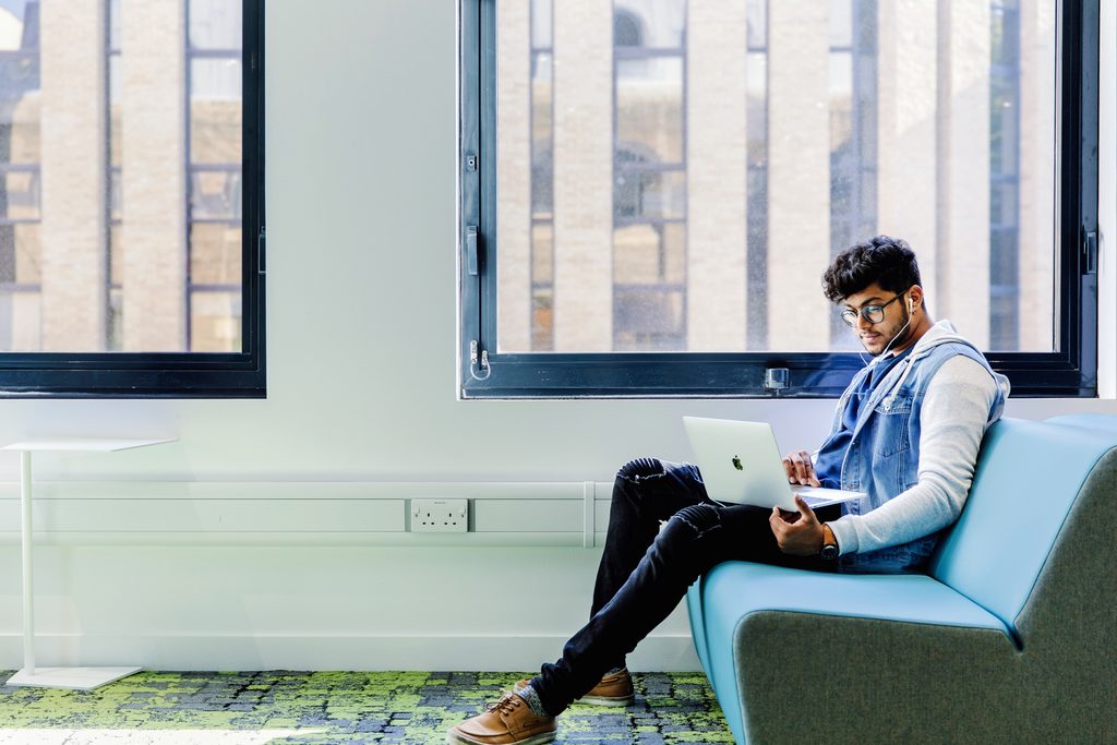 International student at Kaplan International College studying on his laptop