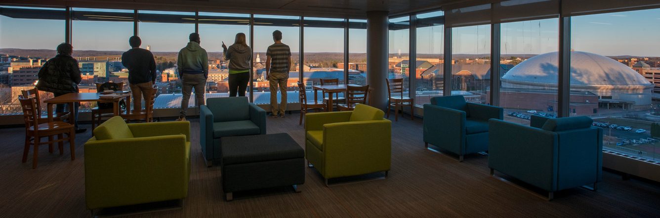 Students looking through the window in a study lounge