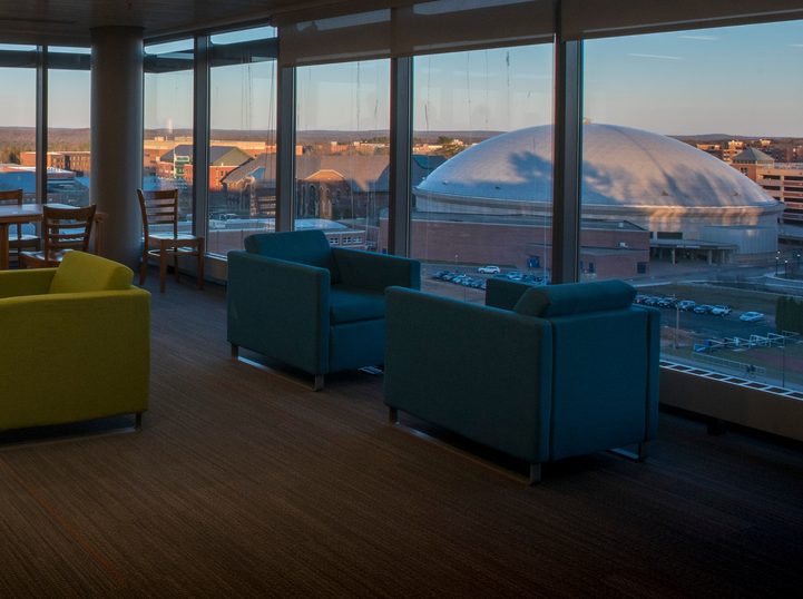 Students looking through the window in a study lounge