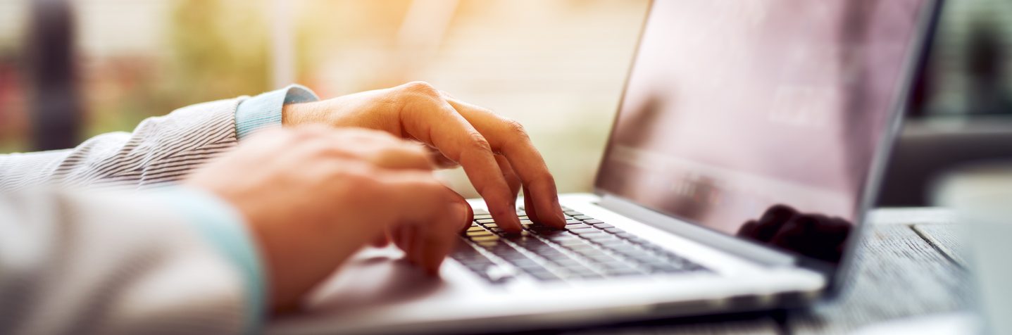 Closeup of man typing on laptop