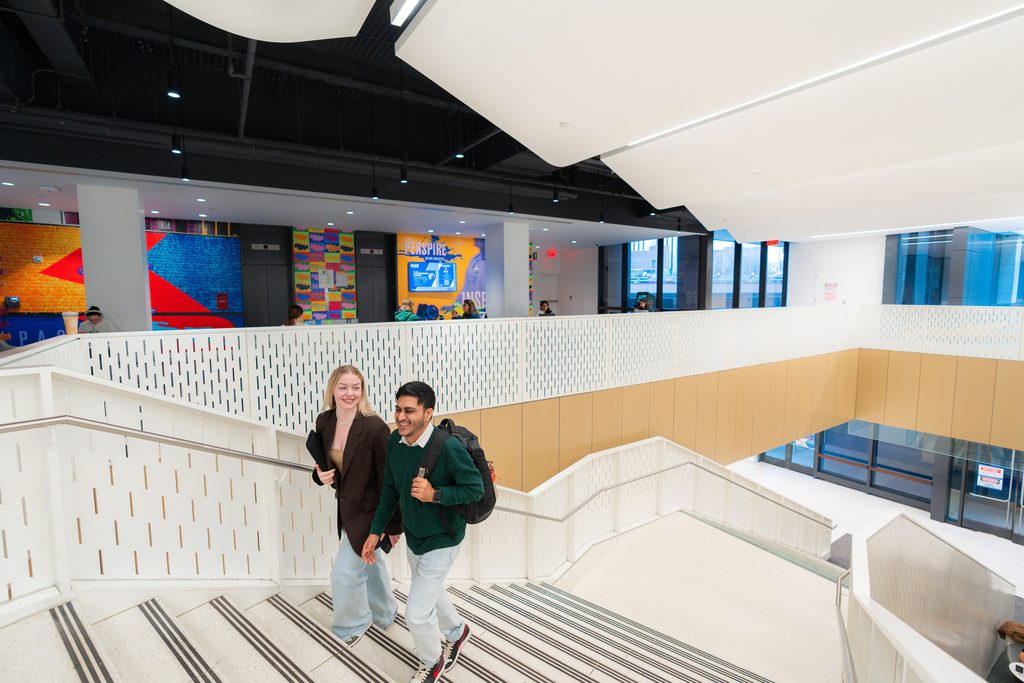 Students walking on the stairs at Pace NYC campus