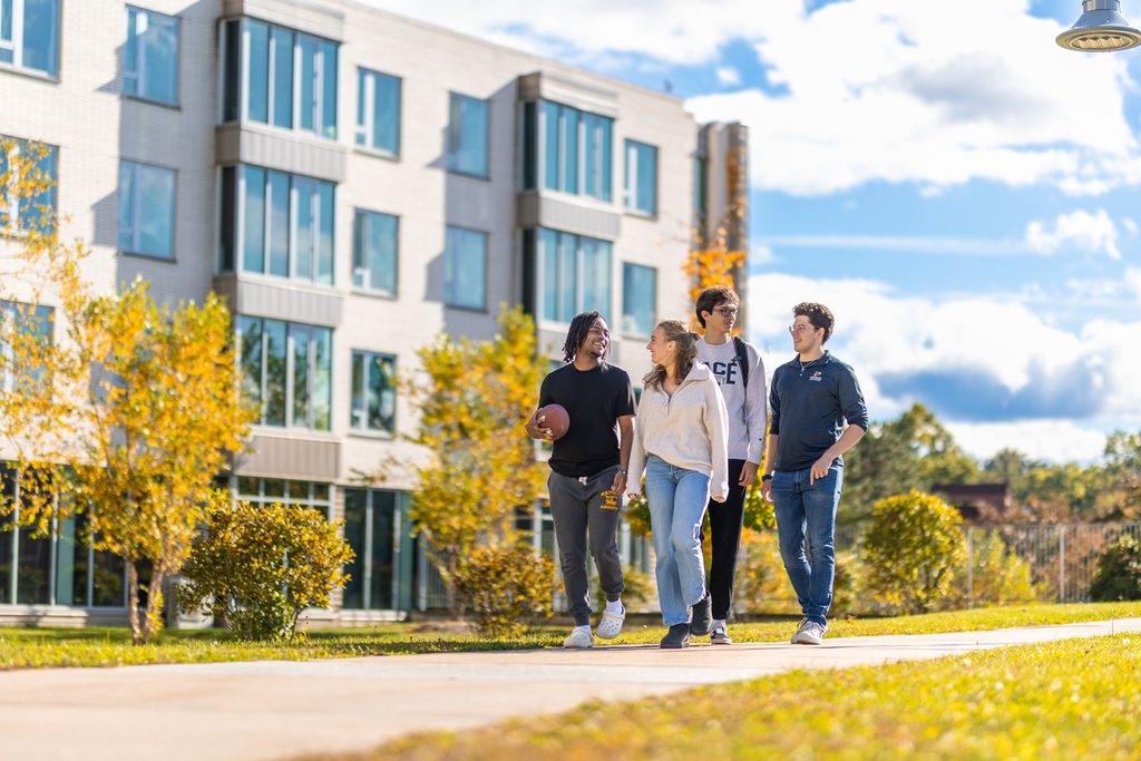 4 Pace university students walking on the Westchester campus