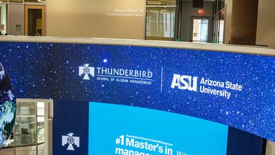 Thunderbird School of Global Management logo on screen at Downtown Phoenix campus building