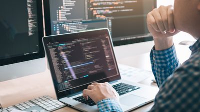 Programmer coding on the laptop