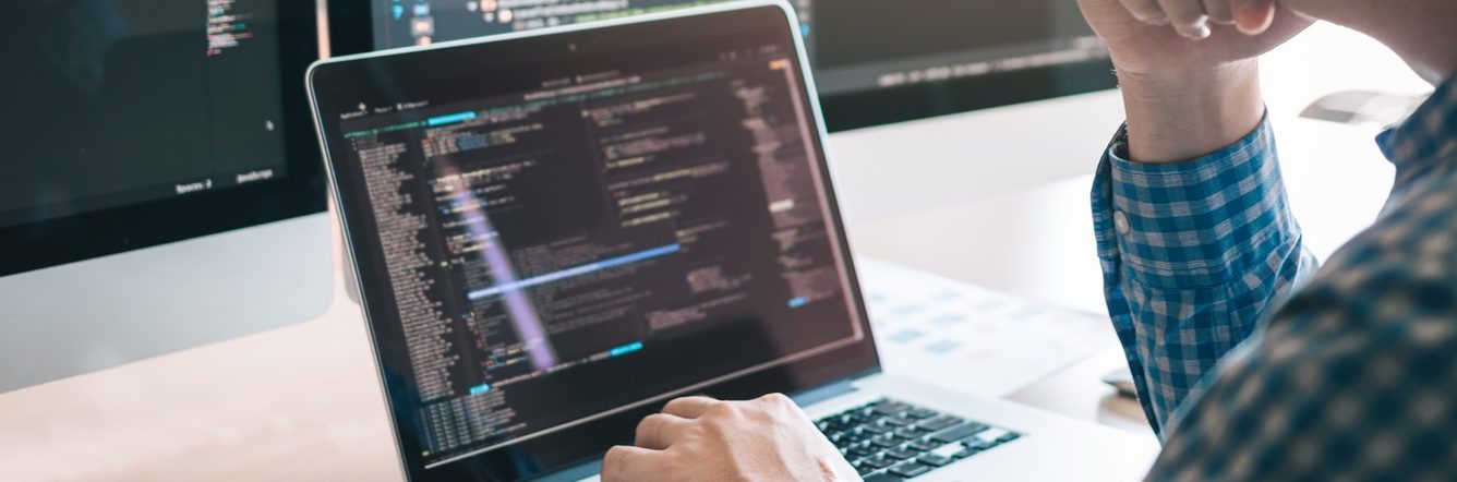 Programmer coding on the laptop
