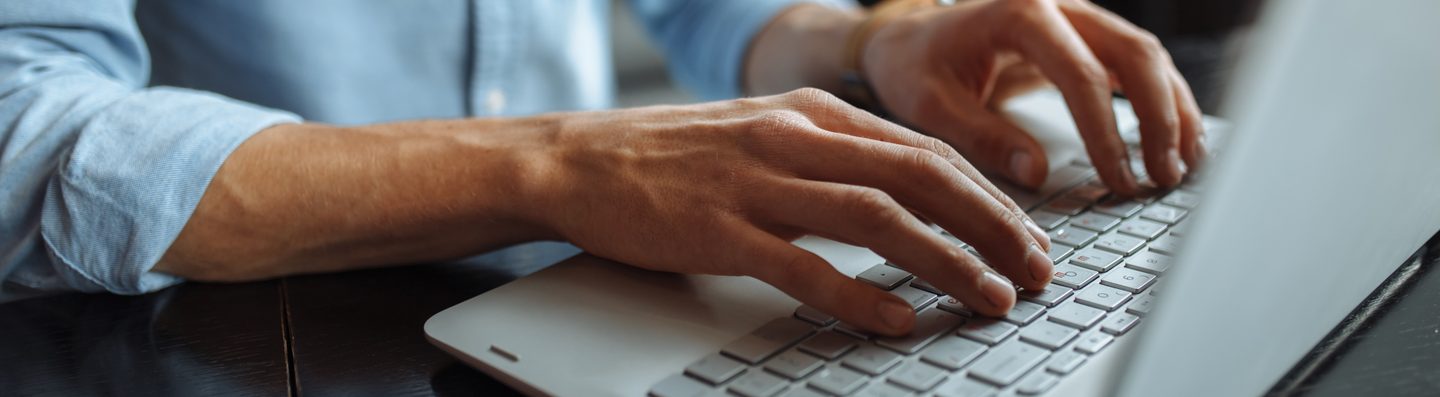 Close up of hands typing on laptop
