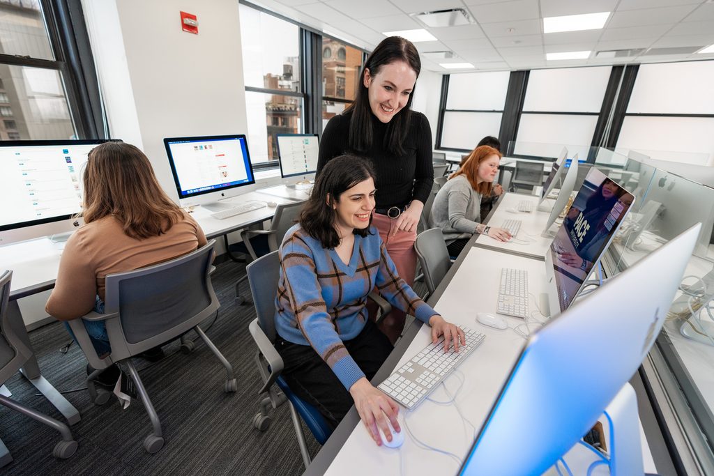 Two Pace students looking at a computer