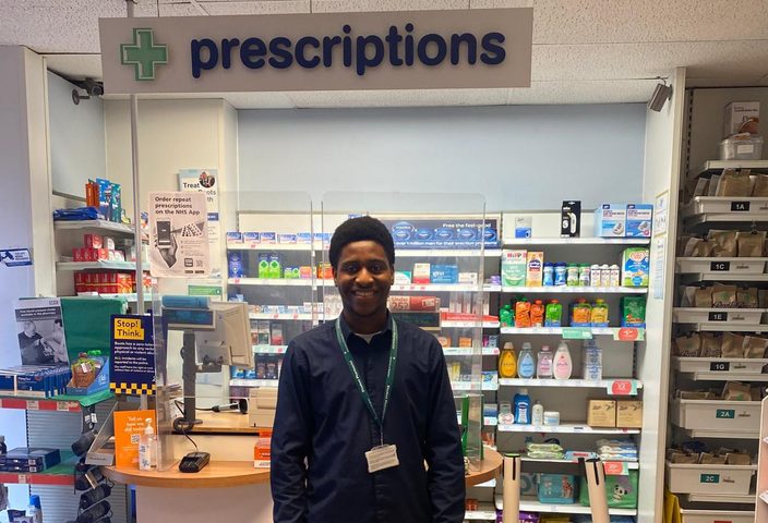 James stannding in a pharmacy