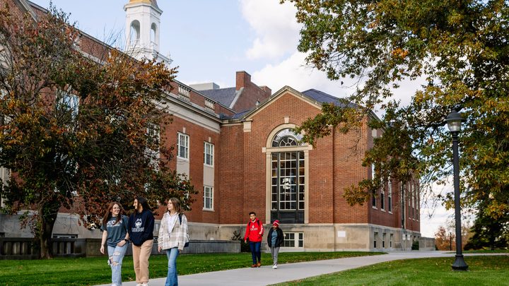 A group of UConn students walking by the campus building