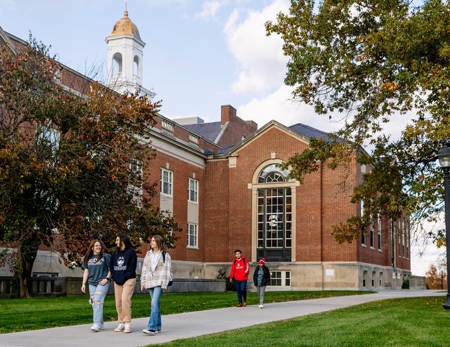 A group of UConn students walking by the campus building