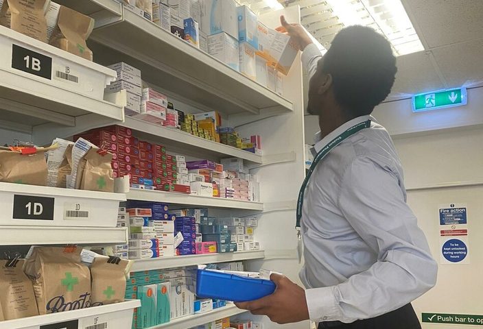 James checking the pharmacy shelves