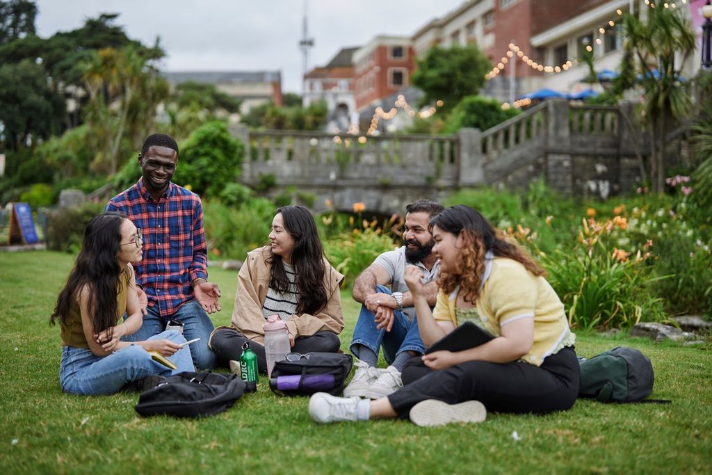Students chatting lying on the grass