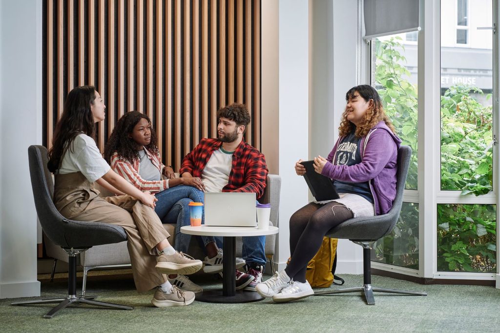 A group of students sitting down and chatting