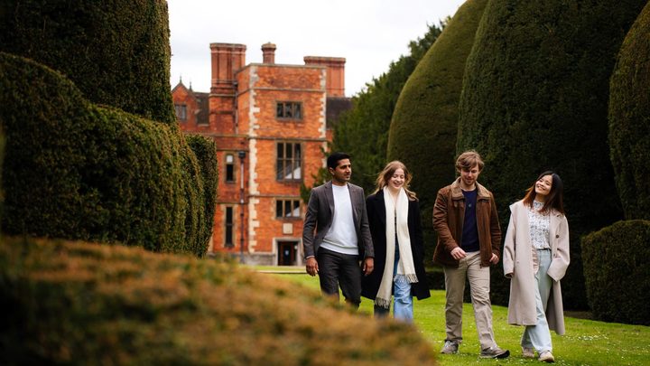 A group of students walk in the campus