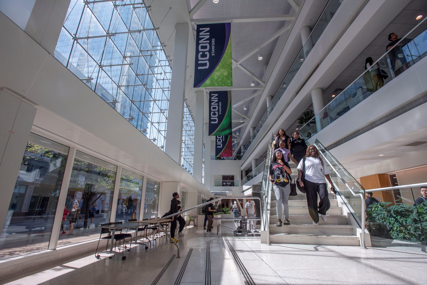 Students walking down the stairs in the courtyard at the Stamford campus