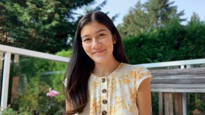 Jaime Chang posing professionally in a floral garden