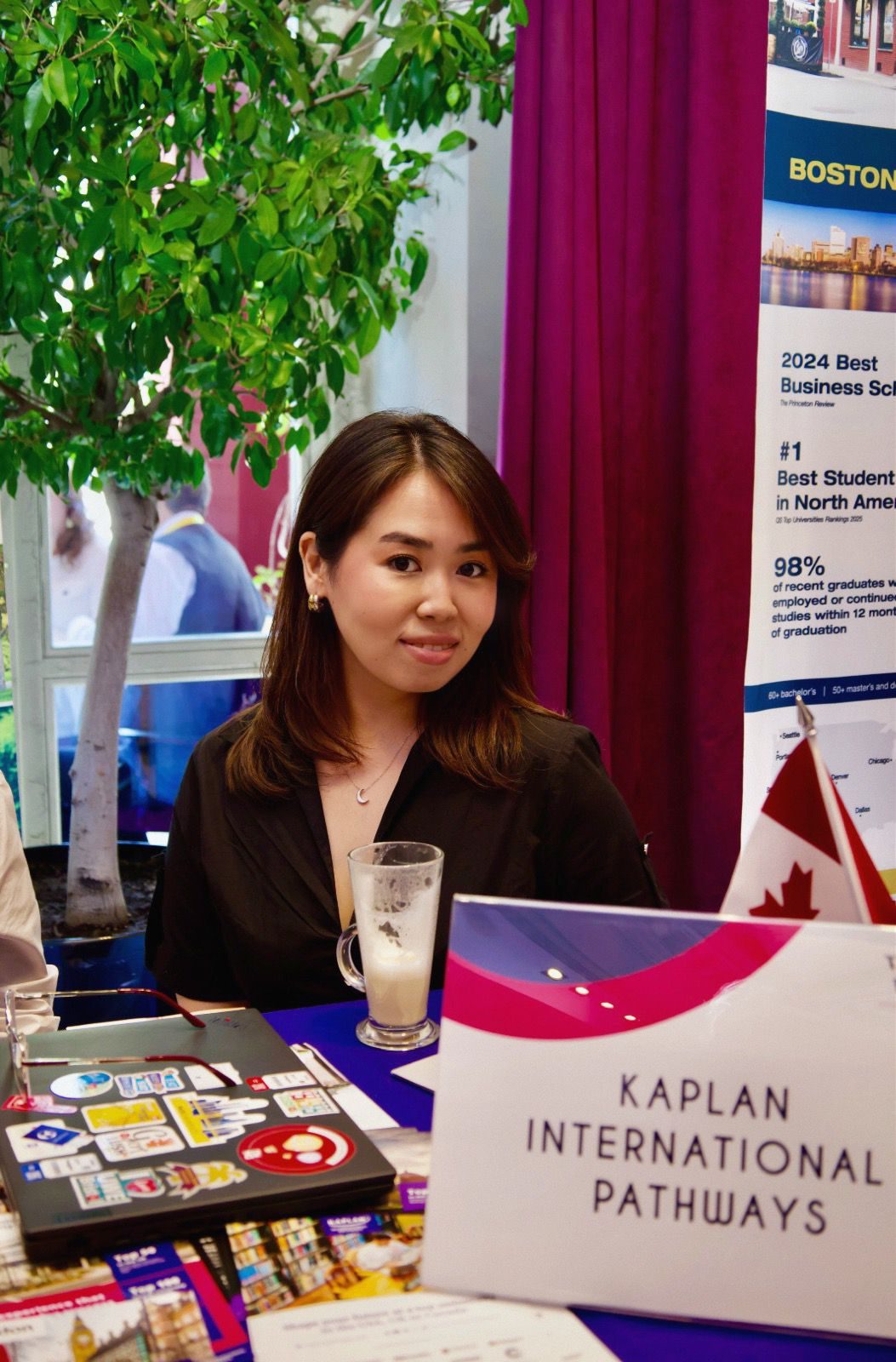 Aruzhan sitting down at a student fair