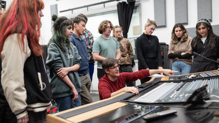 Students receiving instruction in an audio production and sound recording studio at Emily Carr University.
