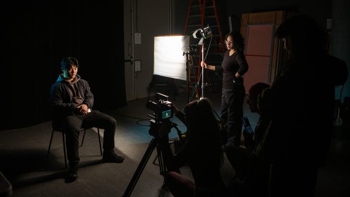 Students working on a film and media production project in a studio environment at Emily Carr University.
