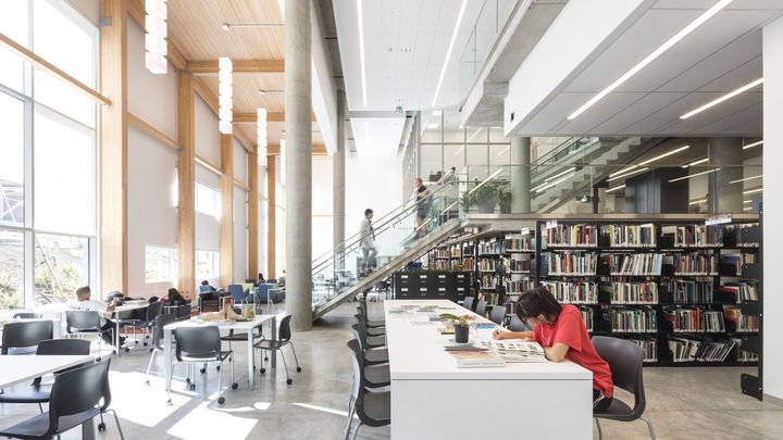 Emily Carr University library and study space with students using tables, bookshelves and collaborative learning areas.