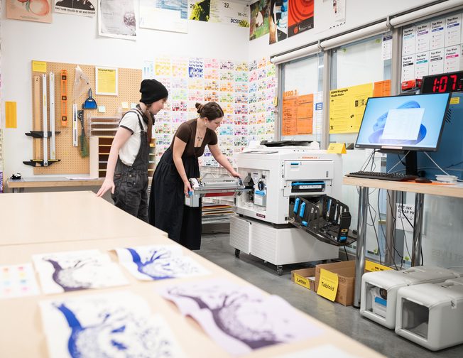 Students working in a printmaking and production studio at Emily Carr University